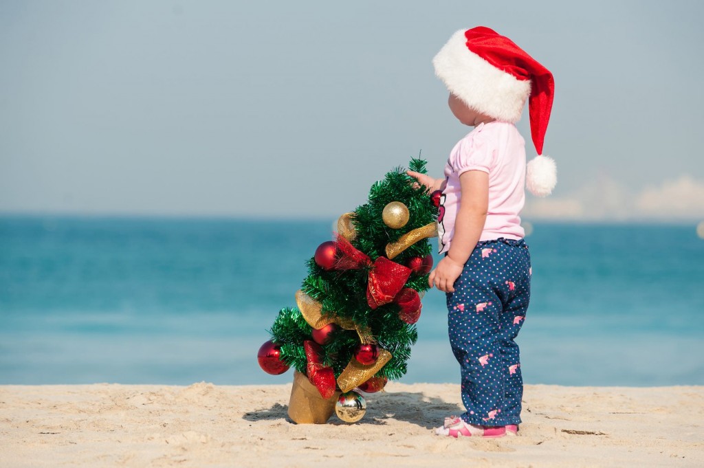 little girl draws a Christmas tree on the beach,_shutterstock_343030898