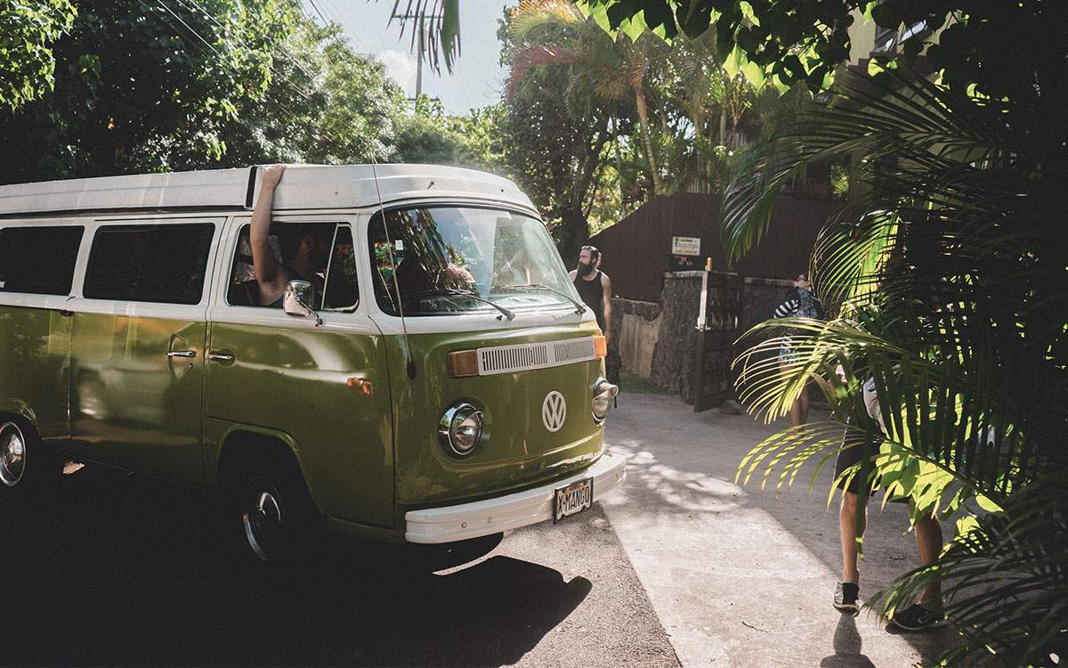 Parked van with trees surrounding.