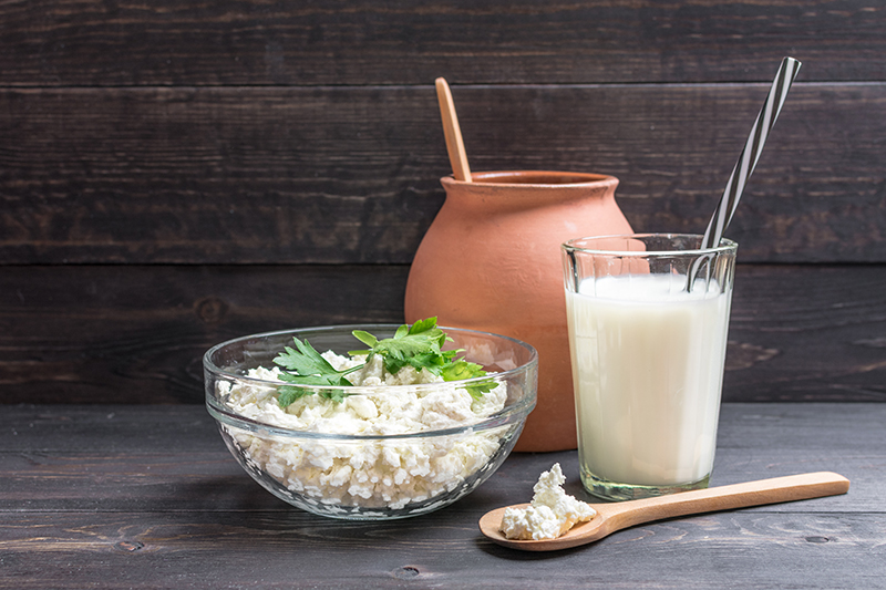 Fresh plain homemade cottage cheese and kefir - fermented drink in Russia