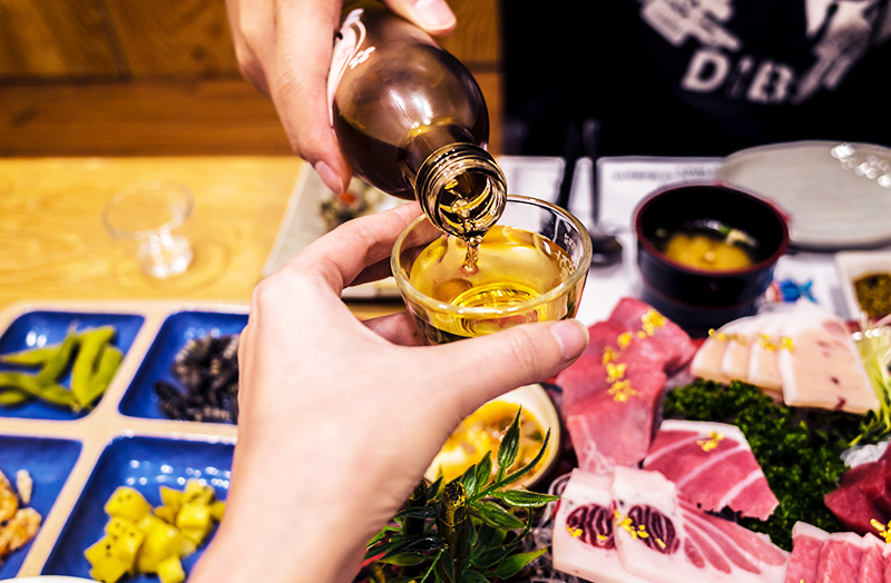 Pouring a glass of Soju - fermented drink in Korea