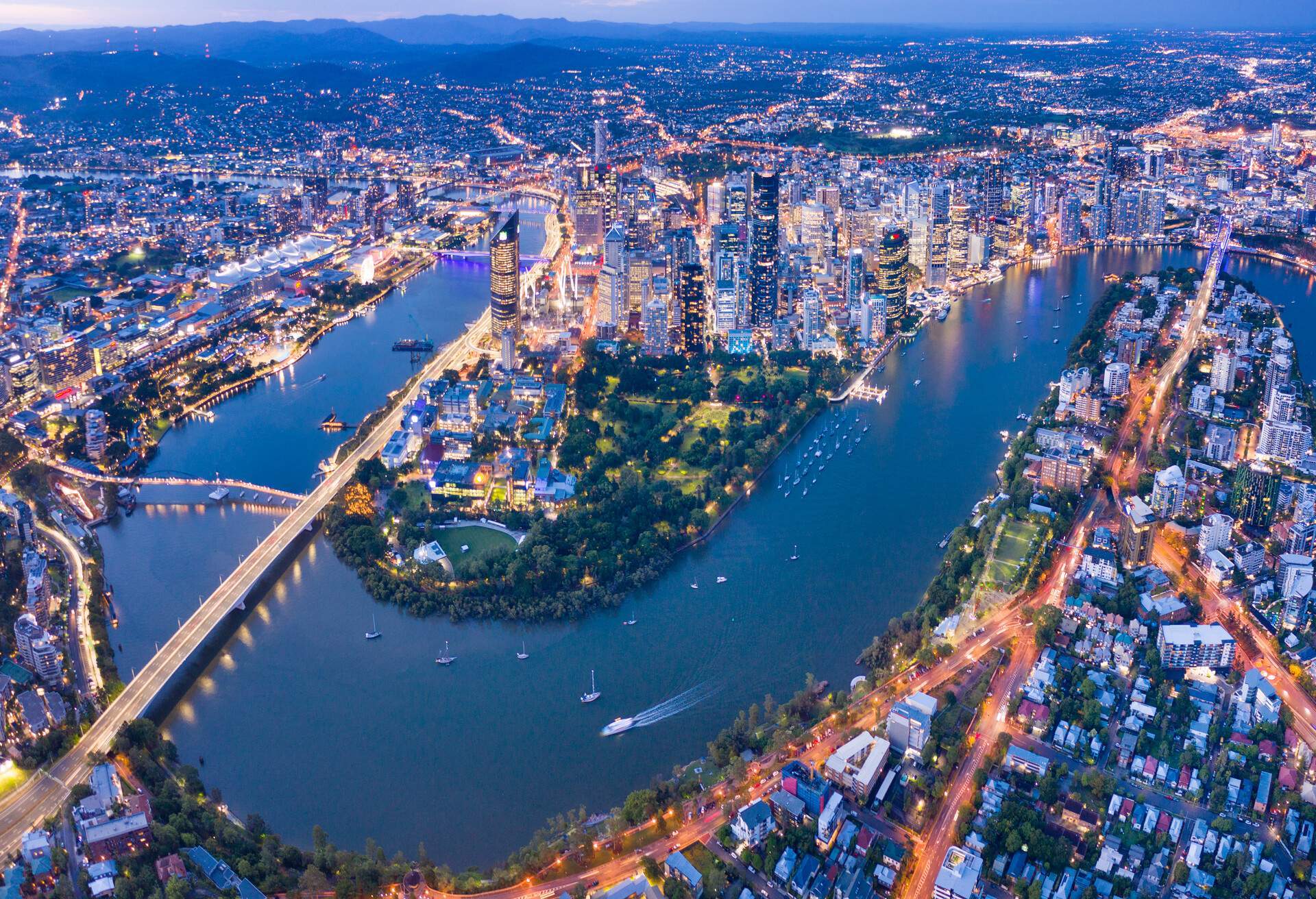 Brisbane Skyline Night Panorama with the famous illuminated Story Bridge, Botanical Garden and Whell, Queensland, Australia. 