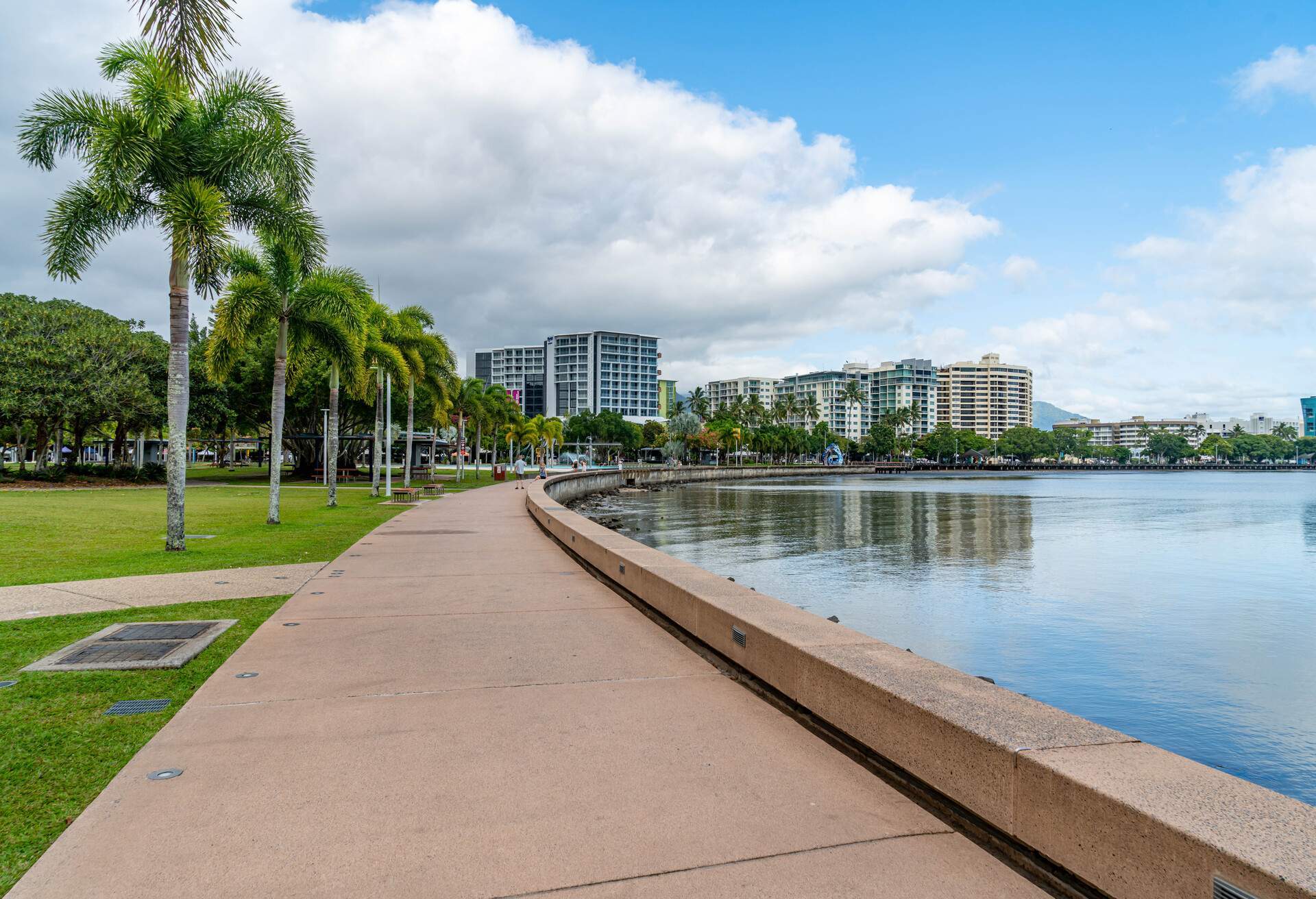 A view of Cairns Esplanade Lagoon, a large free public pool next to the beach in Cairns, Queensland, Australia.