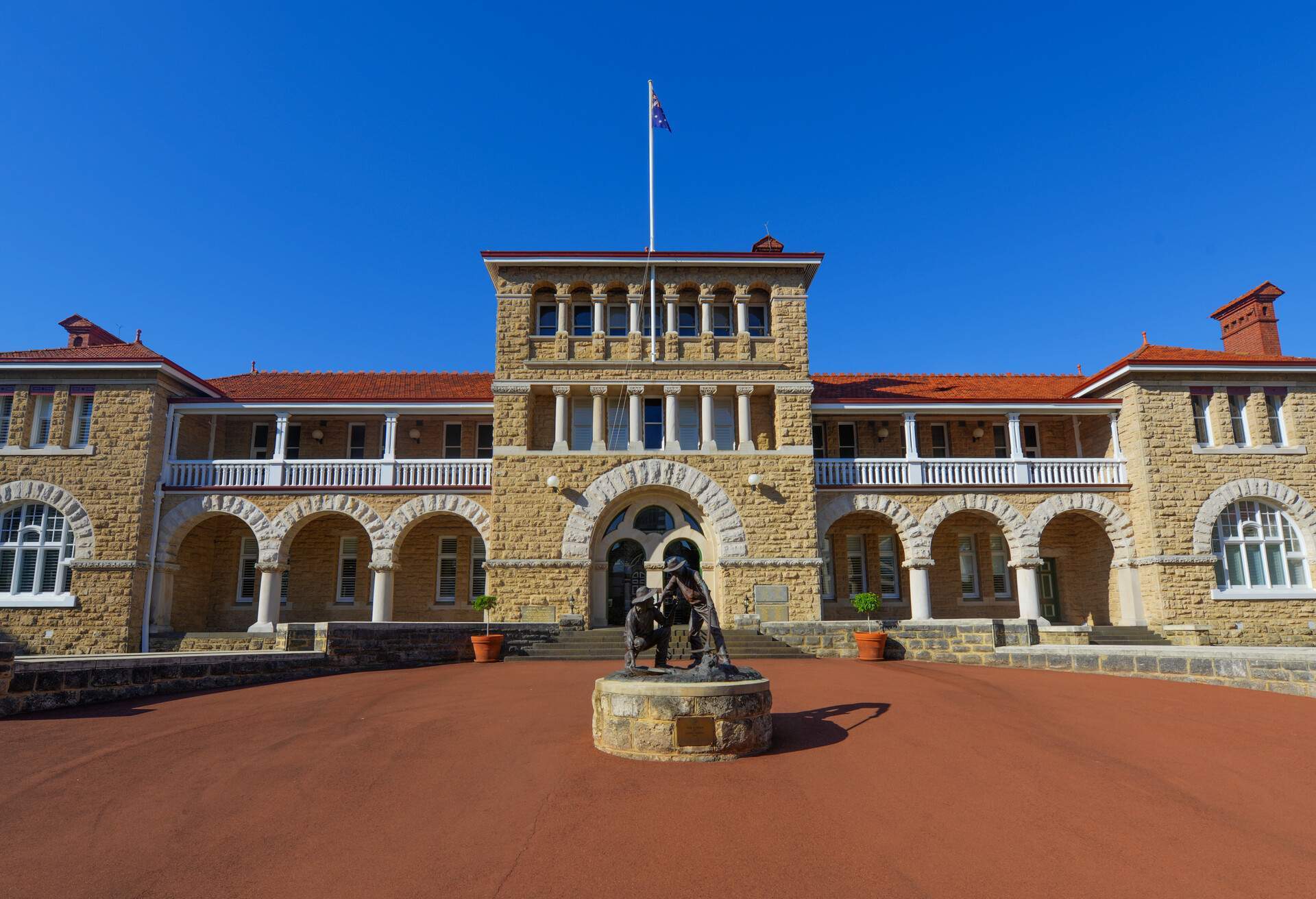 Perth Mint building, one of three branches as part of the Royal Australian Mint. Limestone building built in 1899. Facade with a statue of prospectors striking gold.