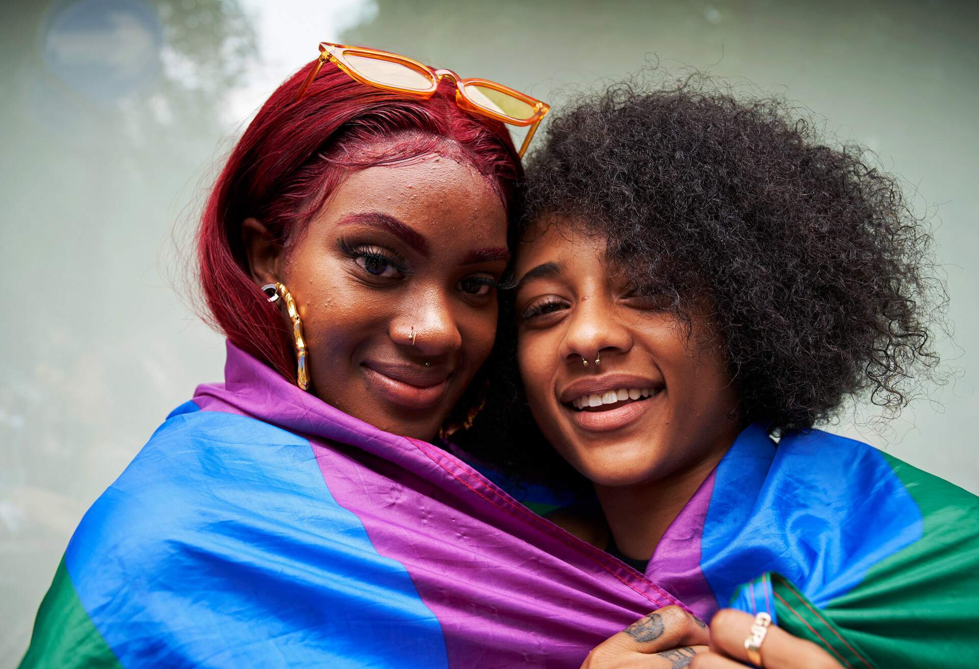 Two women wrapped themselves in a pride flag.