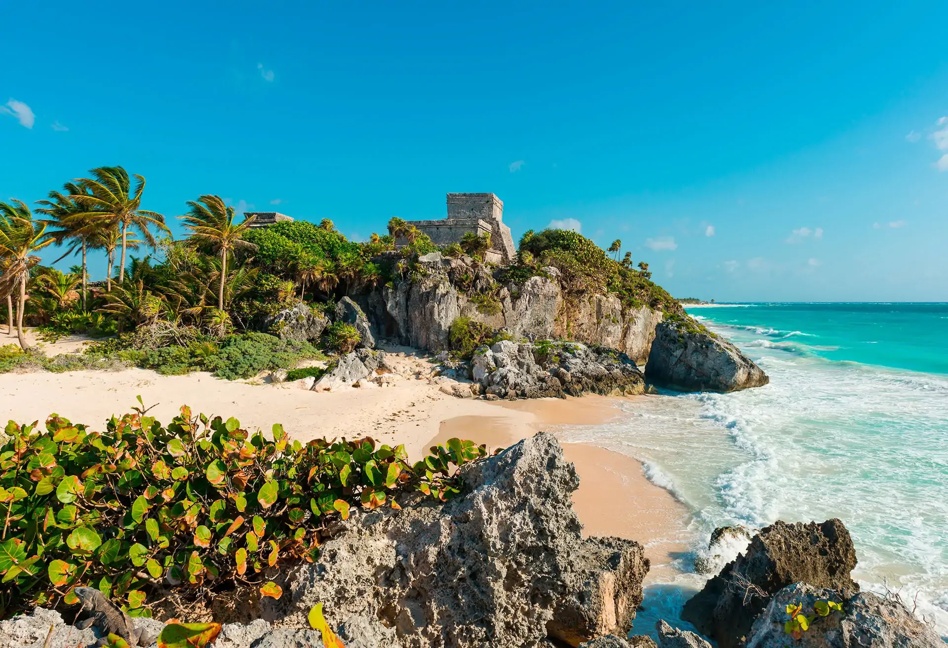 Ancient ruins atop cliffs by the turquoise sea in beautiful Tulum, Mexico
