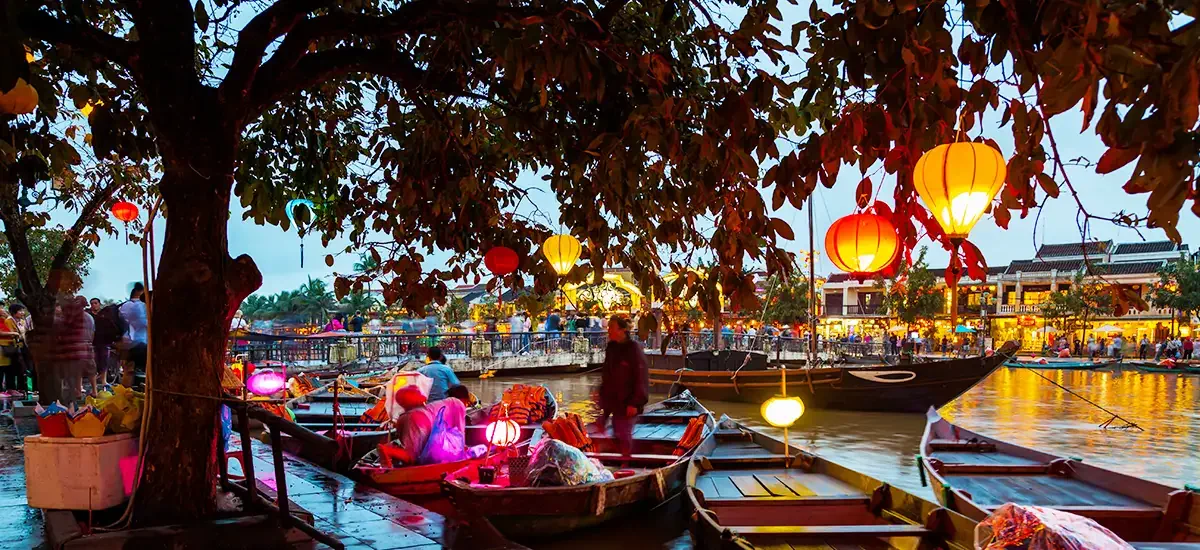 Hoi An, Vietnam. Street view with traditional boats on a background of ancient town