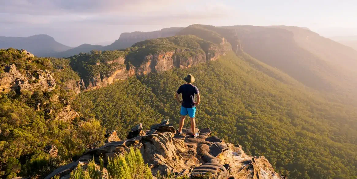 Header photo | Man standing at the peak of Blue Mountains| GETTYIMAGES - WALKERPOD IMAGES