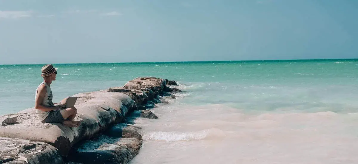Header photo | Man Laptop Beach Working Remote | Shutterstock