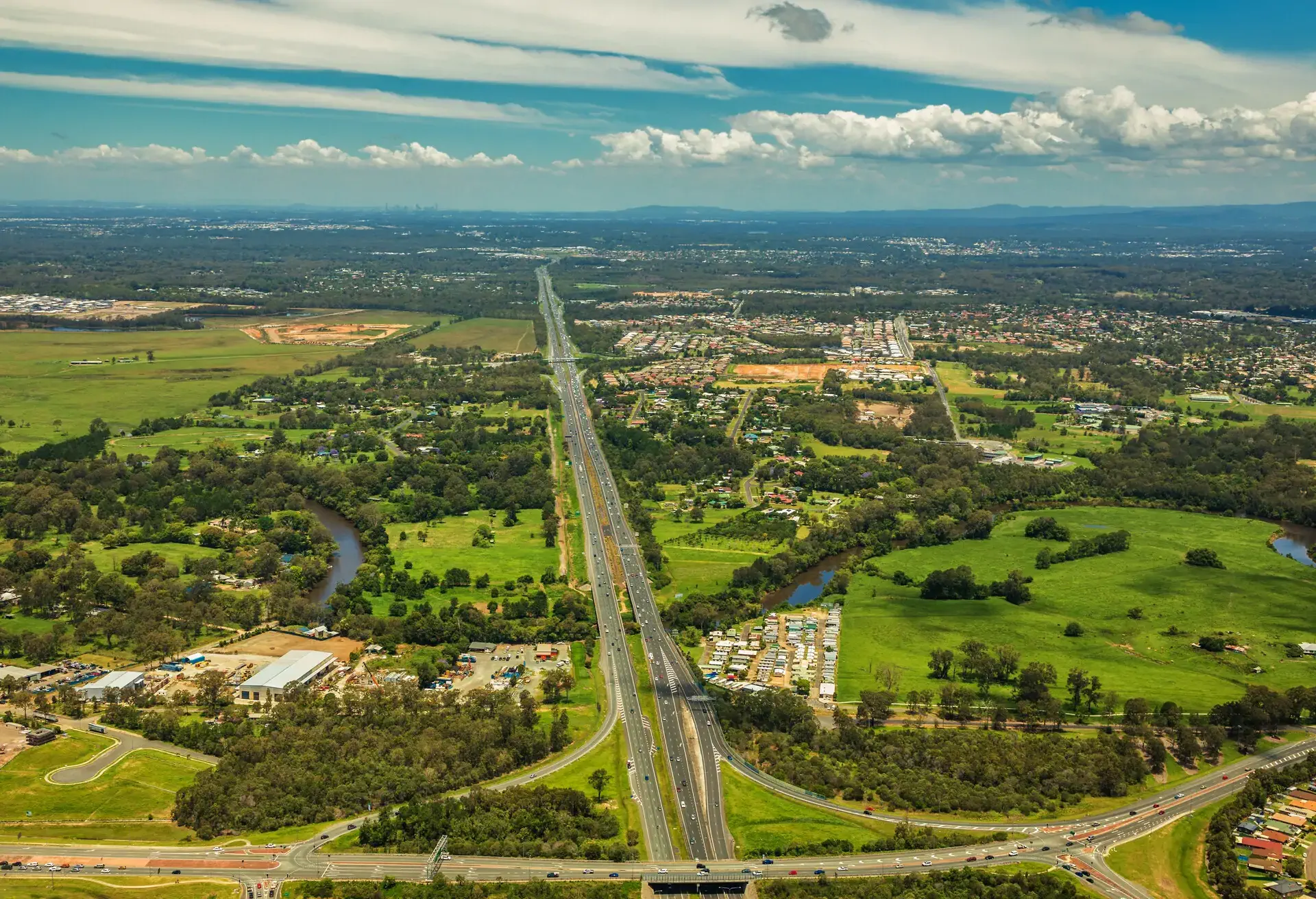 Aerial view of Caboolture and Bruce highway to Brisbane with Bribie Island Road crossing, Queensland, Australia
