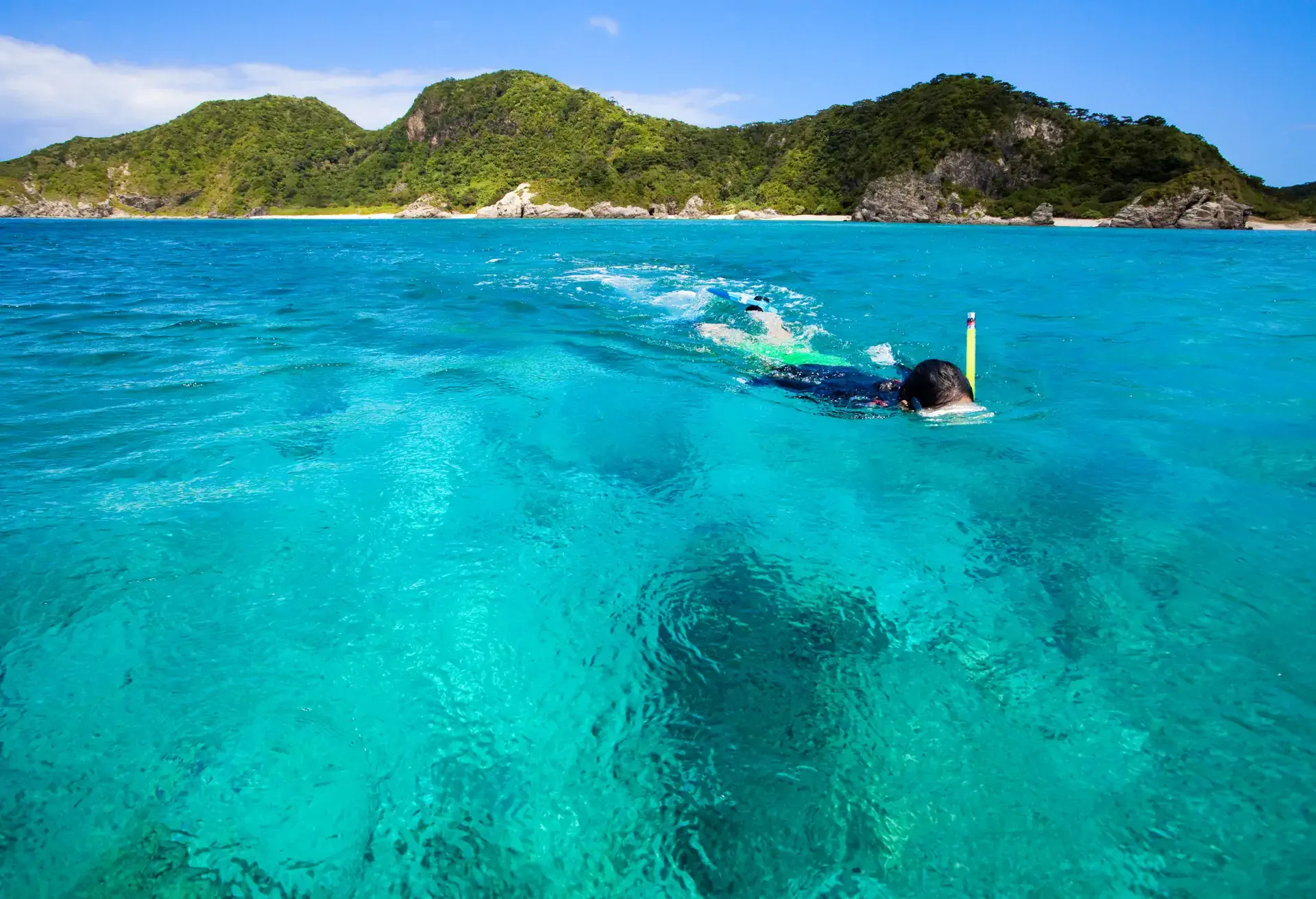 Girl snorkeling in clear blue water of Okinawa islands; Shutterstock ID 35931319; Purpose: Header iomage; Brand (KAYAK, Momondo, Any): Kayak