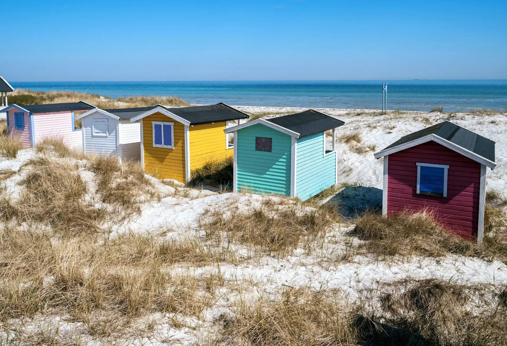 Beach huts or bath cottages on Skanor beach dunes and Falsterbo in South Sweden, Skane travel destination. Domestic tourism concept