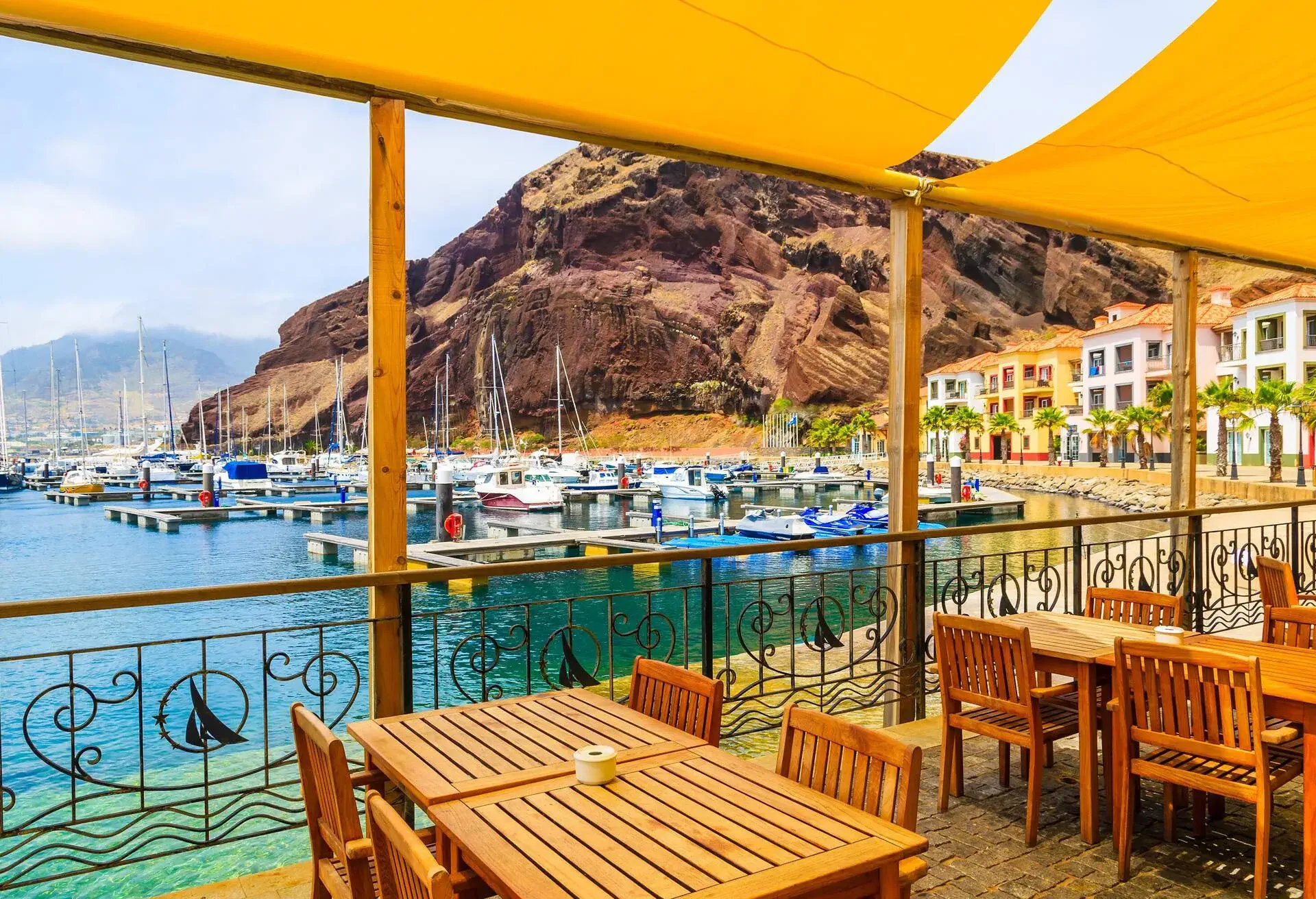 Restaurant terrace in sailing port on coast of Madeira island, Portugal; Shutterstock ID 669584497; Purpose: Portugal; Brand (KAYAK, Momondo, Any): KAYAK